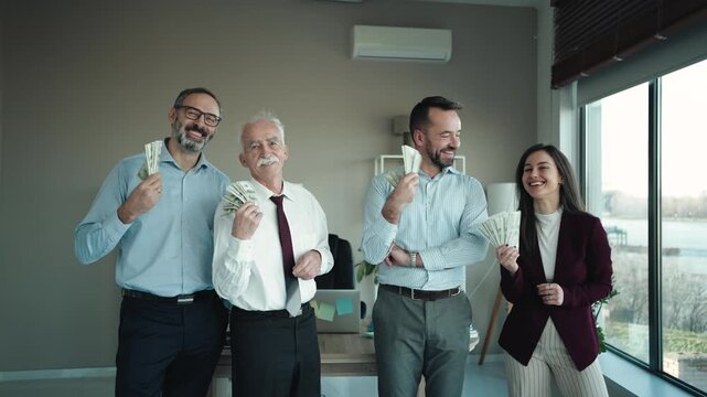 Group of Powerful Businessmen With Money Counting Money in Corporate Office