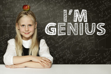 Happy child student sitting in classroom on school chalkboard background. Math education concept