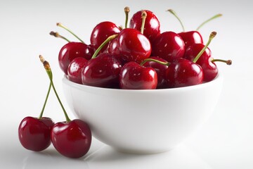 Bowl of ripe red cherries on a clean white background