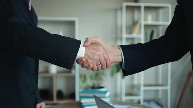 Close-Up of Senior and Middle Aged Businessmen Shaking Hands