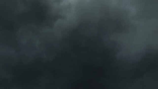 Dramatic and foreboding dark storm clouds gathering in the sky, signaling impending severe weather and a powerful atmospheric event. A cloudy and gloomy day with a sense of tension and natural drama