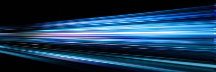 Streaks of vibrant blue illumination rush across a deep black background creating an abstract sense of motion.