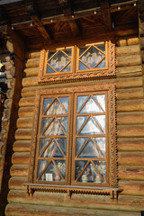 Beautiful traditional wooden windows with unique designs, warm natural texture and charming architectural details, authentic rural and vintage style.
