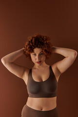 Obraz premium Confident young woman poses in studio showcasing body positivity and self-love