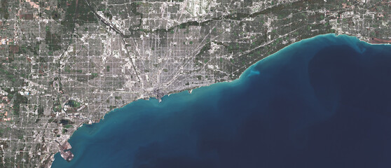 Fototapeta premium Satellite view of Chicago illustrating dense urban infrastructure, transportation networks, and Lake Michigan. This image supports discussions on sustainable megacities