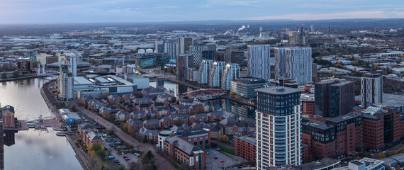 Obraz premium A wide aerial panorama showcasing the modern architecture of Salford Quays, featuring MediaCityUK and the Manchester Ship Canal