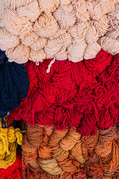 Multicolored yarn bundles stacked in a vibrant, textured pattern. Rabat, Morocco