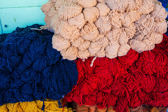 Multicolored skeins of yarn stacked in a vibrant, artistic arrangement. Rabat, Morocco