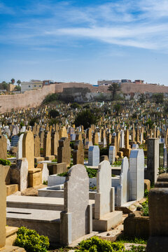 Rows of diverse gravestones in a large cemetery under a clear blue sky. Rabat, Morocco