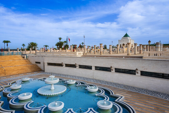 Historical site with ornate fountains and columns under a blue sky with scattered clouds. Rabat, Morocco