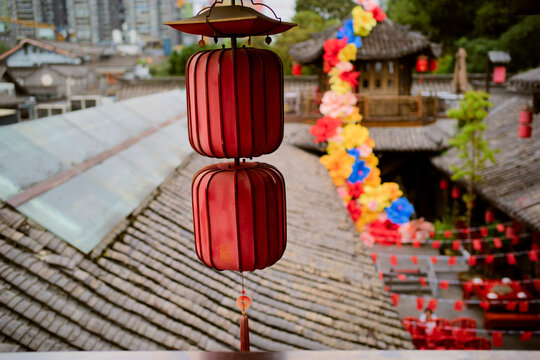 Red lanterns hanging in a traditional Asian courtyard with colorful decorations in the background. Chengdu, Sichuan, China