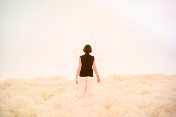 Person standing in a field of fluffy material with a soft, white background. Hongkong, China
