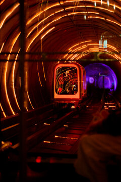 Futuristic train journey through an illuminated tunnel with vibrant lights. Shanghai, China