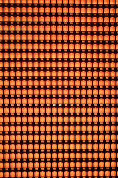 Repetitive grid pattern with warm orange and black squares, resembling an abstract mosaic. Shanghai, China