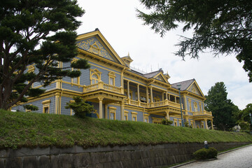 Former Hakodate Ward Public Hall with Stone Steps and Forested Backdrop
