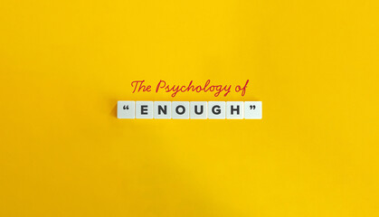 The Psychology of Enough Conceptual Text on Yellow Background with Letter Tiles