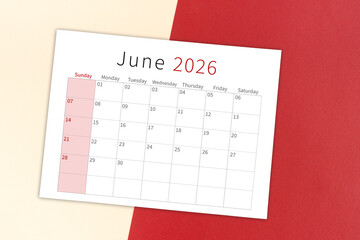 June 2026 calendar page on yellow and red background.