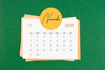 November 2026 calendar page on green background.