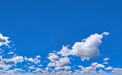 A blue sky filled with some white many clouds creating a peaceful and inspiring natural landscape scene. Free frame cloud composition for banner with big copy space inscription.