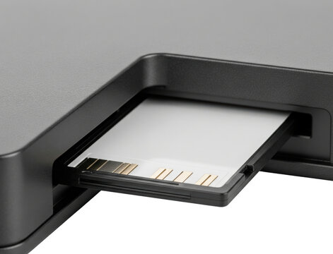 Black memory card inserted into electronic device slot isolated with transparent background