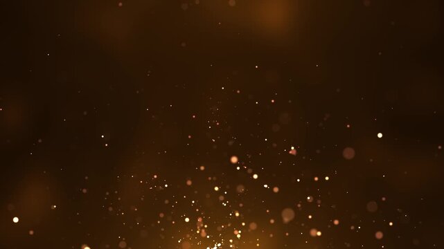 abstract animated concept featuring golden particles rising upwards for birthday and holiday celebrations. A looping 4K background with a bokeh effect and glowing particles against a dark background.