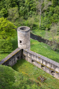 A top view of a stone battle tower near the forest

