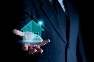 Businessman holding house icon, Real estate concept. House on Hand. Property insurance and security concept.