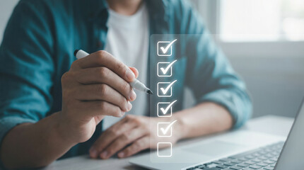 Hand marking task completion on a digital checklist representing achievement generic office goals and productivity