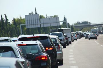Heavy traffic congestion on highway with cars, tunnels, and traffic signals.