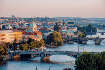 Obraz premium Morning Riverscape Scene, Historic Structures Glow Warmly With Morning Sunlight Over Peaceful River