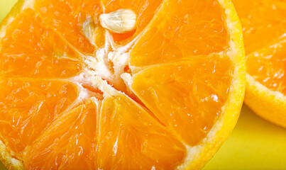 Macro close-up of fresh orange cut in half, revealing juicy segment, pulp texture and natural citrus pattern
