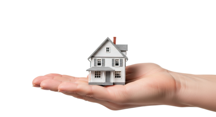 A hand holding a miniature house against a white background.