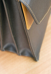 selective focus on brown leather briefcase on table