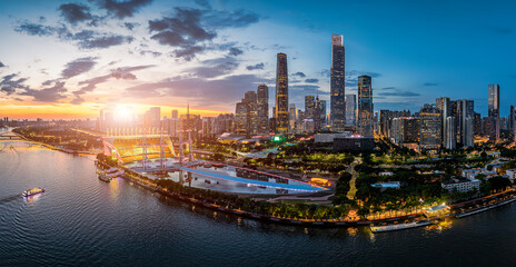 Aerial view of the modern Guangzhou city skyline and Pearl River during a vibrant sunset in China.