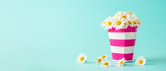 White daisies in a striped pink and white pot on a turquoise background, floral banner with copy space, springtime freshness, cheerful and vibrant flower arrangement for decorative display