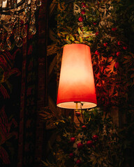 Dimly lit vintage interior with glowing wall lamp and patterned wallpaper