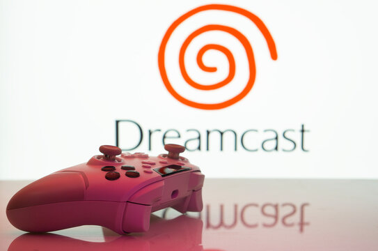 Dhaka, Bangladesh- 20 Mar 2025: A close-up of a white gamepad with the Dreamcast seen on screen in the background.