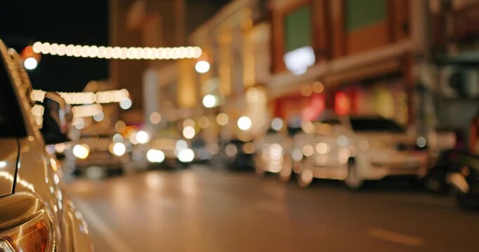 The street at night is not in focus for use as a background.