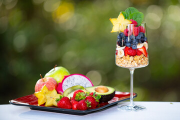 Fruit cocktail on green summer background. Fruit cocktail vitamins healthy food. Superfood with...