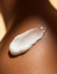 white milk lotion is pouring out of a glass dropper on dark skin, macro texture of the skin on which the lotion is applied
