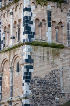 Romanesque stone building of church tower. Architectural detail background. Brickwork and cornerstone architecture background. Romanesque architecture