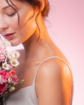 Spring Beauty Woman Smelling Flowers, Soft Light Perfume Concept