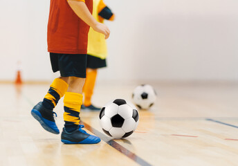 Child Practicing Indoor Soccer Ball Control. Youth Football Training and Skill Development Session