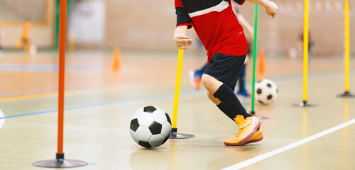Indoor Youth Soccer Training Drill. Child Dribbling Football Through Poles During Kids Sports Practice
