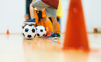Youth Indoor Soccer Training Session. Kids Practicing Football Dribbling and Agility With Cones