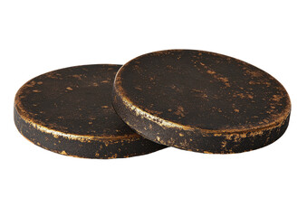 Two dark, round coasters, textured surfaces, black background