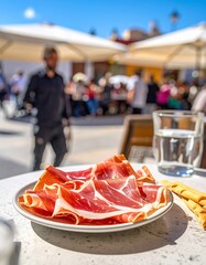Firefly Jam&oacute;n Ib&eacute;rico on a terrace with people enjoying Spanish cuisine in daylight