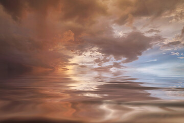 Cumulus sunset clouds with sun setting down,Clouds reflextion on during sunset