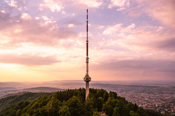 Obraz premium Zurich Switzerland Uetliberg telecommunications network broadcasting antenna tower station with colorful clouds during sunset 
