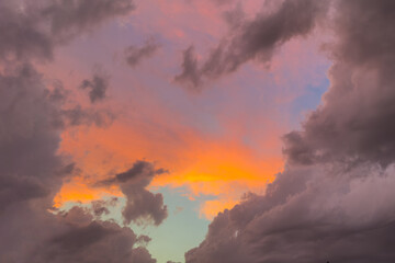 Fototapeta premium Colorful sunset sky with dark clouds and with glowing orange horizon